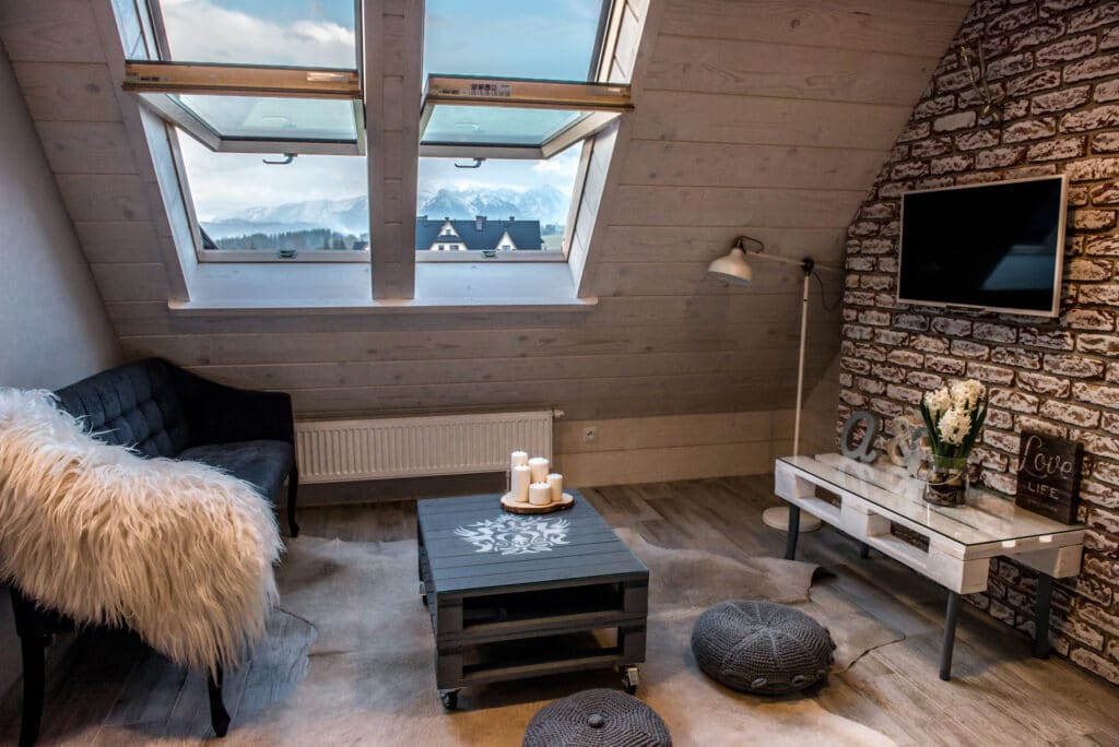 A Silverton sitting area with a stone wall and roof window