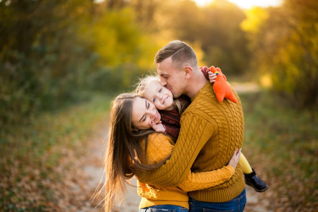 Couple walking through an autumn forest